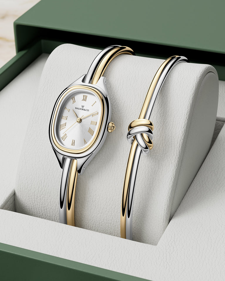  An ellipse shaped womens watch in Rhodium-plated 316L stainless steel from Waldor & Co. with silver sunray dial in brass. Mineral glass with sapphire crystal coating. Seiko movement. The model is Dual Bangle Watch.