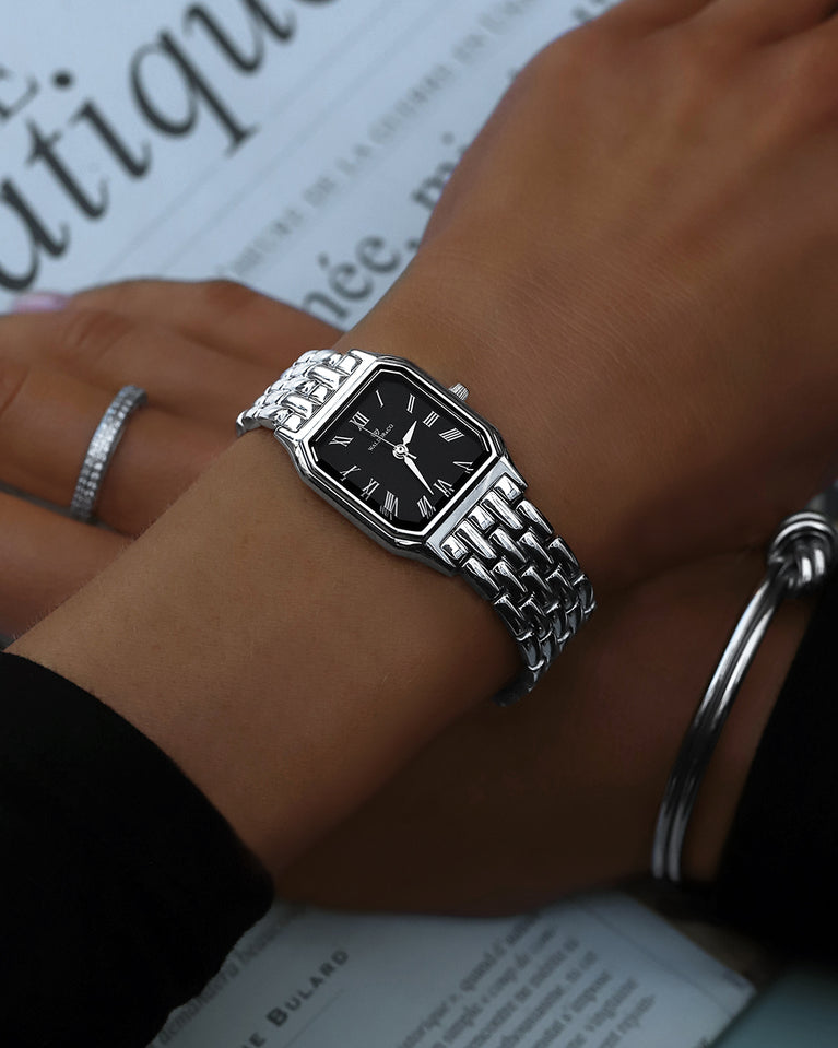 A square womens watch in Rhodium-plated 316L stainless steel from Waldor & Co. with black Diamond Cut Sapphire Crystal glass dial. Seiko movement. The model is Eternal 22 Bellagio.