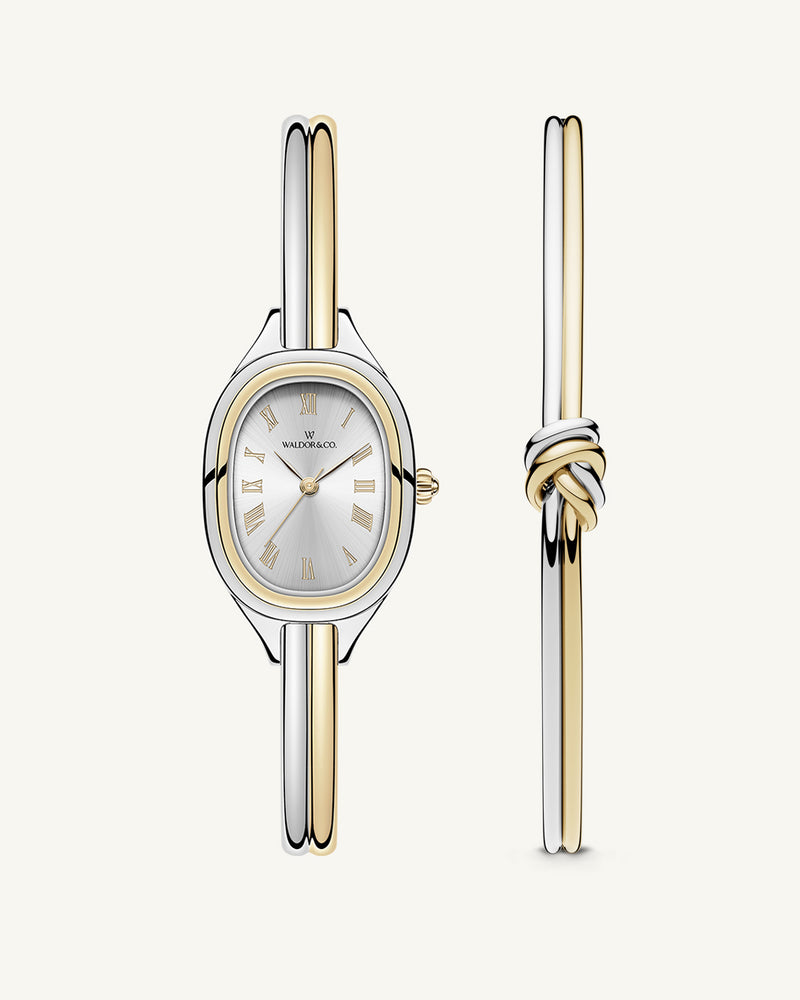 An ellipse shaped womens watch in Rhodium-plated 316L stainless steel from Waldor & Co. with silver sunray dial in brass. Mineral glass with sapphire crystal coating. Seiko movement. The model is Dual Bangle Watch.