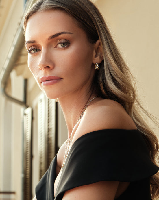 lifestyle_image, Earrings in silver and gold plated-316L stainless steel from Waldor & Co. The model is Dual Knot Earring Polished.