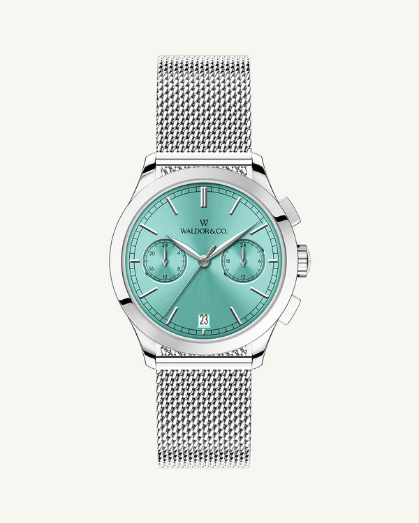 A round womens watch in rhodium-plated silver from Waldor & Co. with turquoise sunray dial and a second hand. Seiko movement. The model is Chrono 36 Sardinia 36mm.