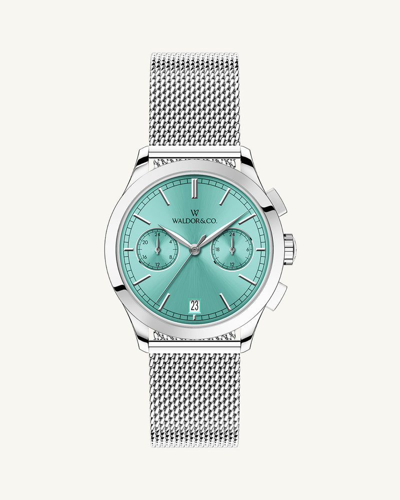 A round womens watch in rhodium-plated silver from Waldor & Co. with turquoise sunray dial and a second hand. Seiko movement. The model is Chrono 36 Sardinia 36mm.