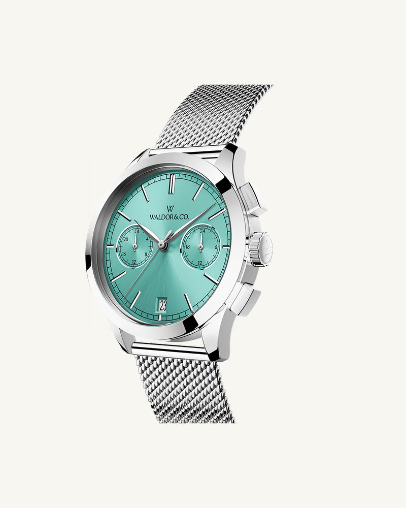 A round womens watch in rhodium-plated silver from Waldor & Co. with turquoise sunray dial and a second hand. Seiko movement. The model is Chrono 36 Sardinia 36mm.