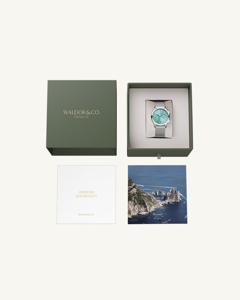 A round womens watch in rhodium-plated silver from Waldor & Co. with turquoise sunray dial and a second hand. Seiko movement. The model is Chrono 36 Sardinia 36mm.