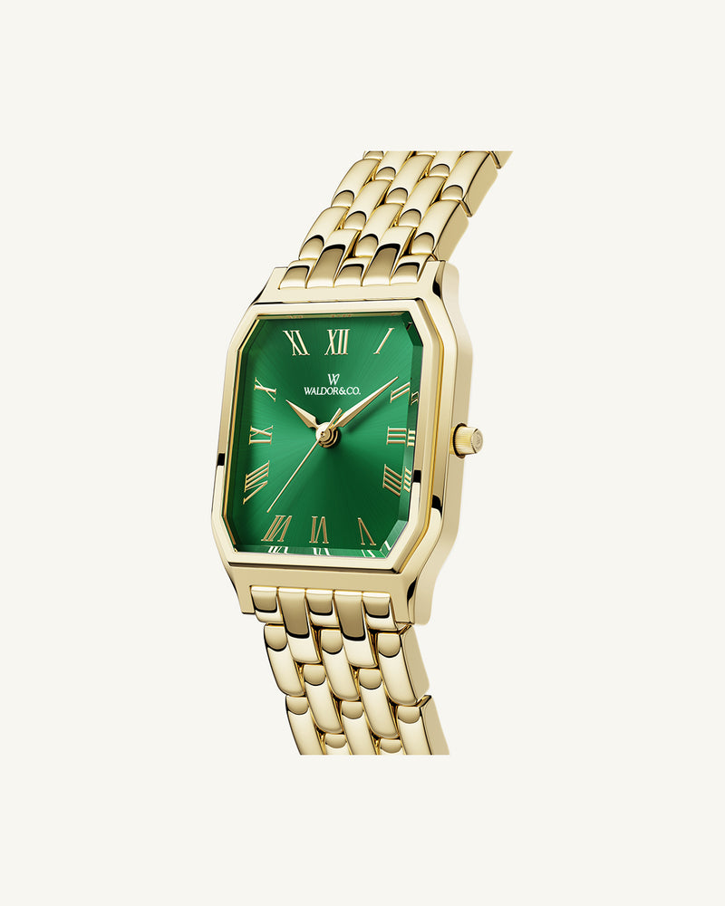 A square womens watch in 22k gold from Waldor & Co. with green Diamond Cut Sapphire Crystal glass dial. Seiko movement. The model is Eternal 22 Bellagio.