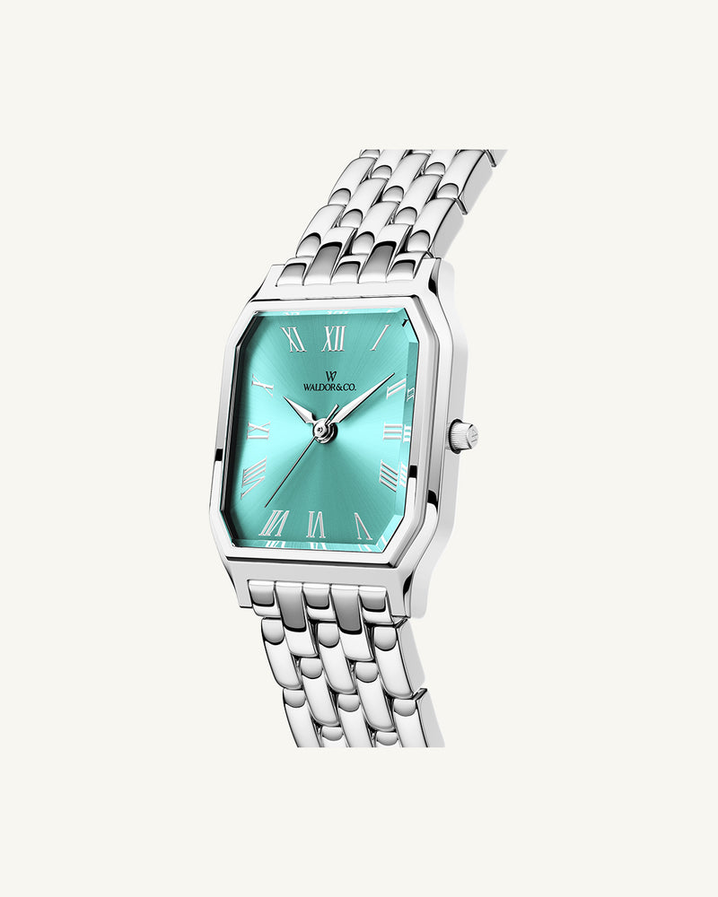 A square womens watch in Rhodium-plated 316L stainless steel from Waldor & Co. with turquoise Diamond Cut Sapphire Crystal glass dial. Seiko movement. The model is Eternal 22 Bellagio.