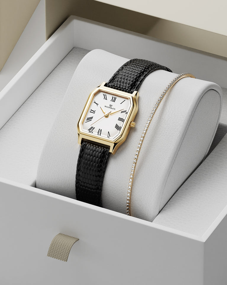 A square womens watch in 22k gold from Waldor & Co. with white Diamond Cut Sapphire Crystal glass dial. Strap in black Genuine leather. Seiko movement. The model is Eternal 22 Varenna.