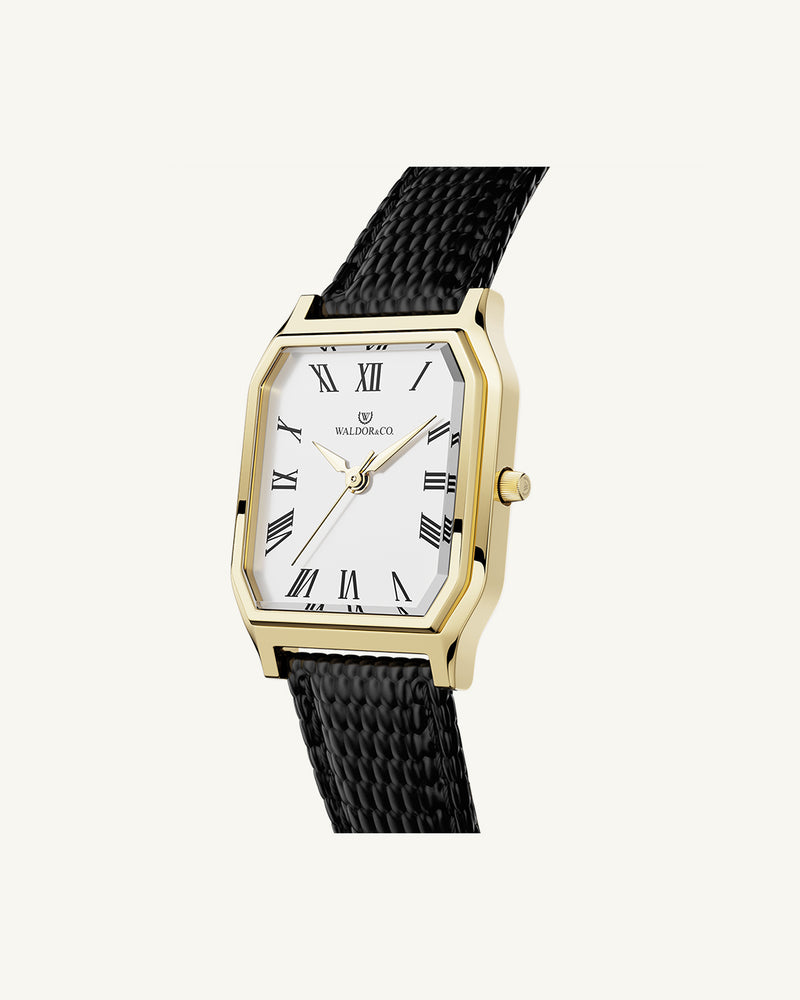 A square womens watch in 22k gold from Waldor & Co. with white Diamond Cut Sapphire Crystal glass dial. Strap in black Genuine leather. Seiko movement. The model is Eternal 22 Varenna. 