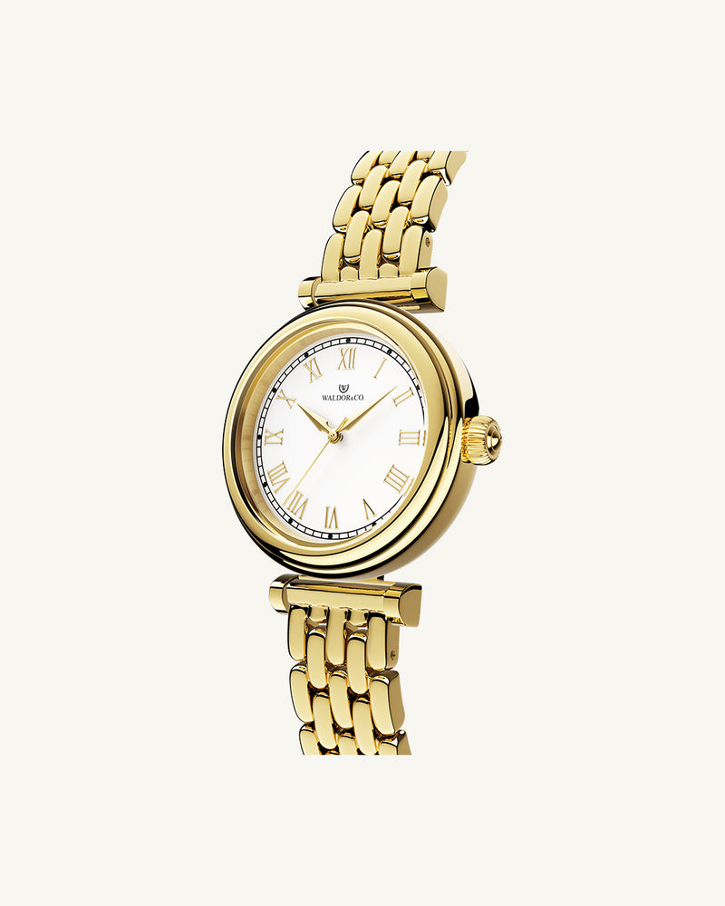 A round womens watch in 22k gold plated 316L stainless steel from Waldor & Co. with white Sapphire Crystal glass dial. Seiko movement. The model is Venia 24 Villefranche.