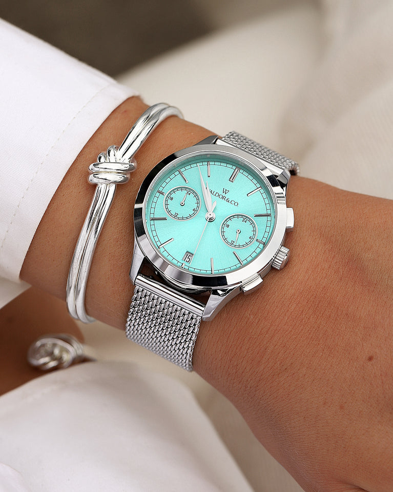  A round womens watch in rhodium-plated silver from Waldor & Co. with turquoise sunray dial and a second hand. Seiko movement. The model is Chrono 36 Sardinia 36mm.