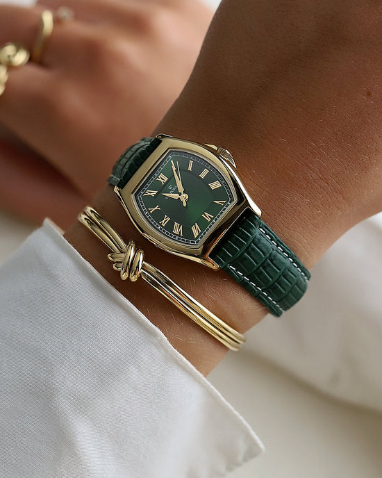 lifestyle_image, A square womens watch in 22k gold plated 316L stainless steel from Waldor & Co. with domed mineral glass dial. Seiko movement. The model is Constant 36 Laglio.