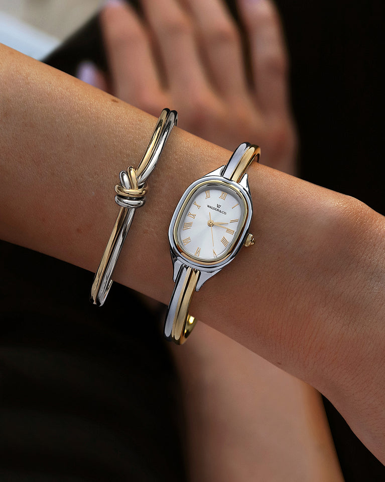  An ellipse shaped womens watch in Rhodium-plated 316L stainless steel from Waldor & Co. with silver sunray dial in brass. Mineral glass with sapphire crystal coating. Seiko movement. The model is Dual Bangle Watch.