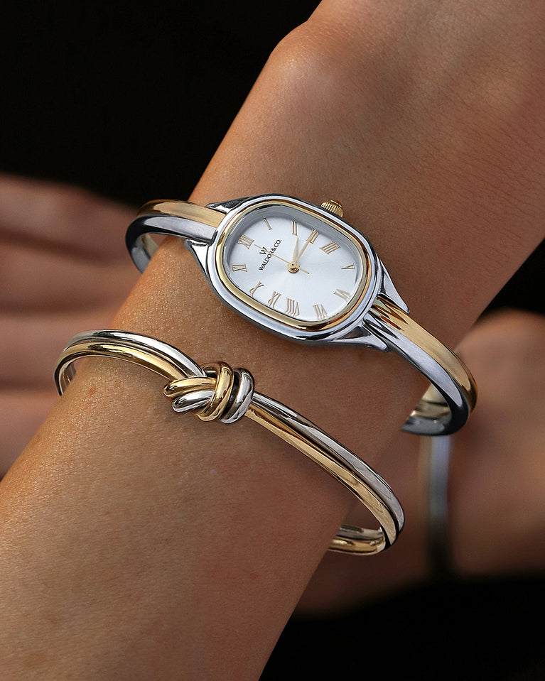  An ellipse shaped womens watch in Rhodium-plated 316L stainless steel from Waldor & Co. with silver sunray dial in brass. Mineral glass with sapphire crystal coating. Seiko movement. The model is Dual Bangle Watch.