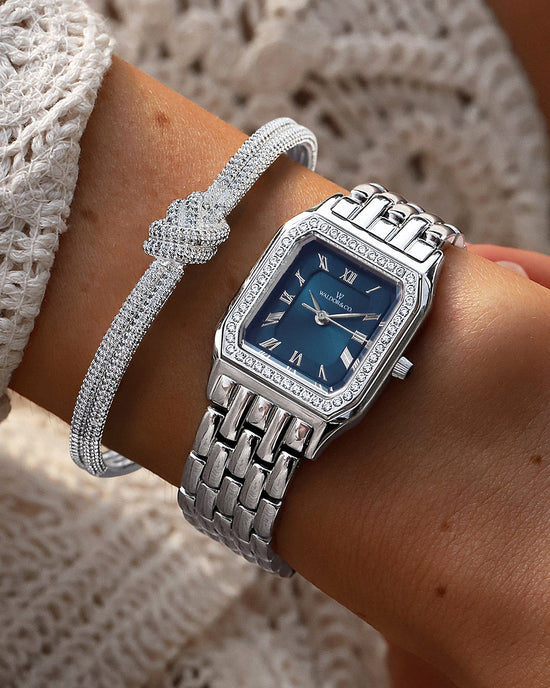 lifestyle_image, A square womens watch in Rhodium-plated 316L stainless steel from Waldor & Co. with dark blue dial. Bezel with premium crystals. Diamond Cut Sapphire Crystal glass dial. Seiko movement. The model is Eternal 22 Bellagio Pavè.